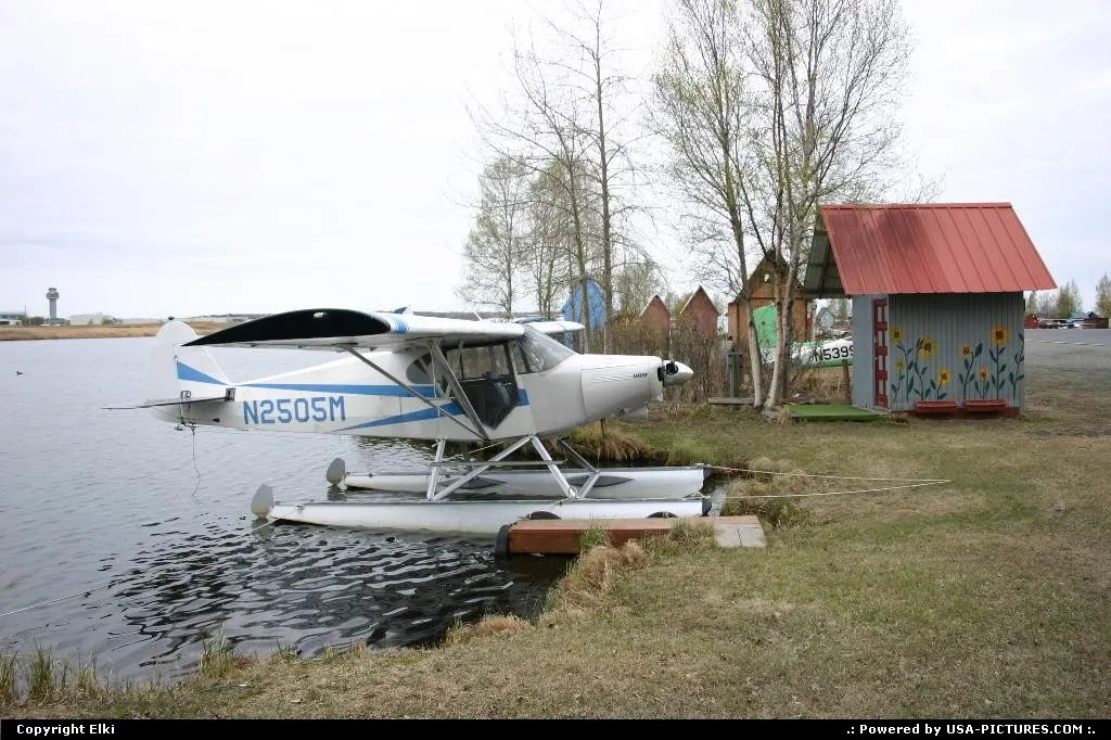 A Piper PA-12 with floaters in Lake Hood