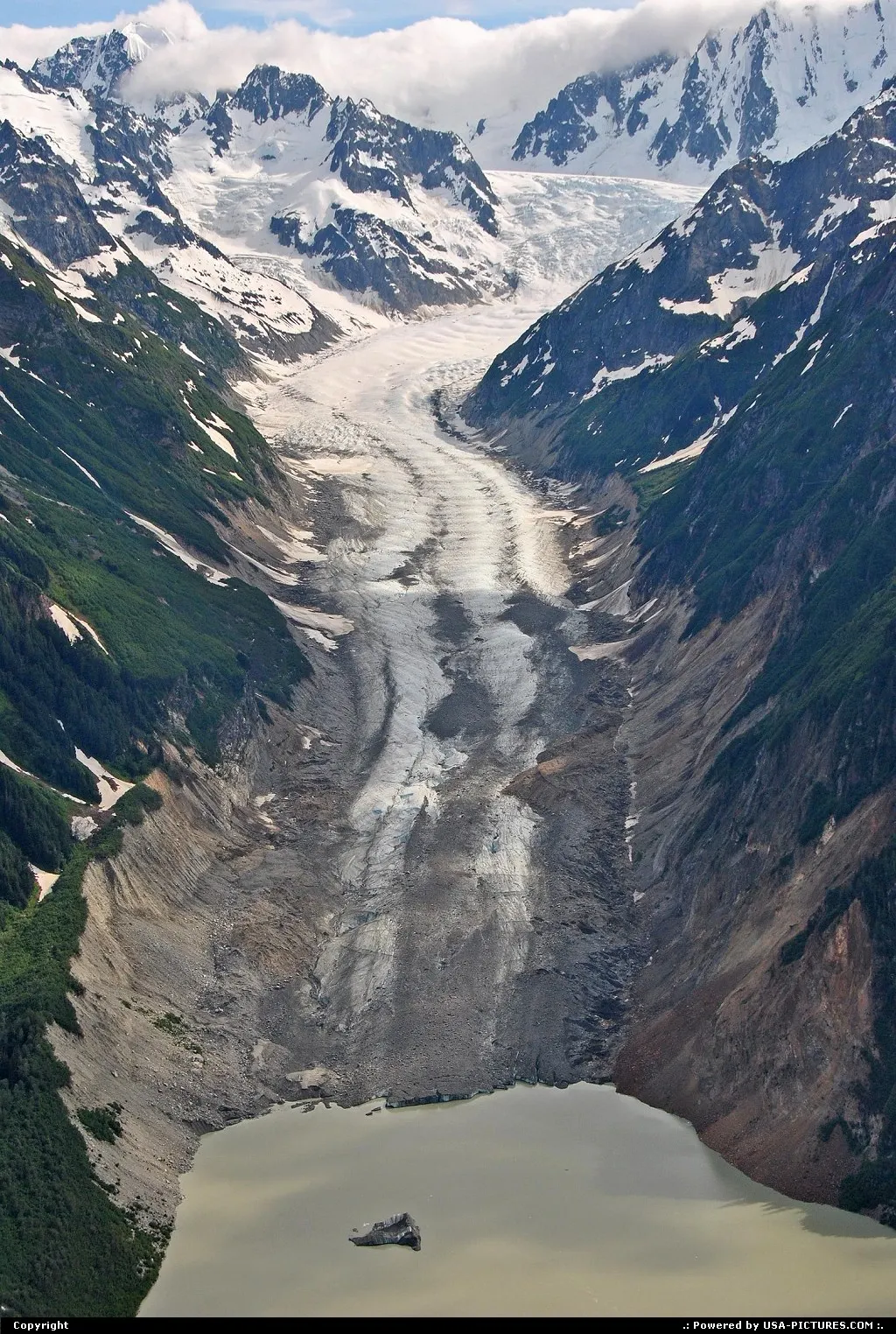 Slow but unstoppable a glacier find its way downwards to end in the bay.