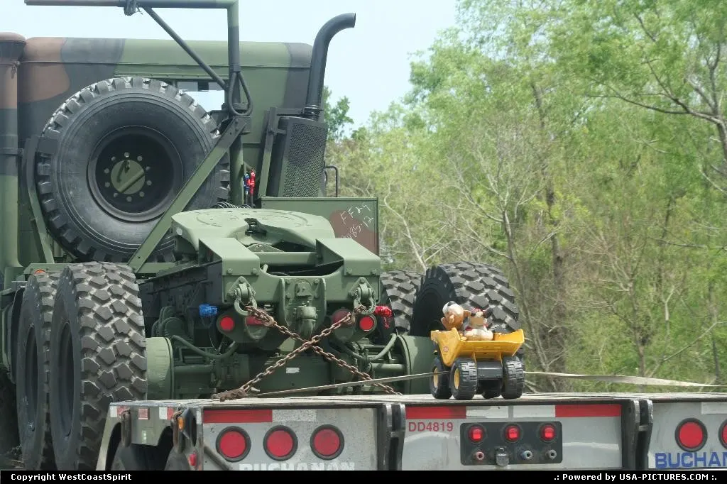 Semi Truck, Army tractor on the flat bed and ... nice little yellow on. Nice!