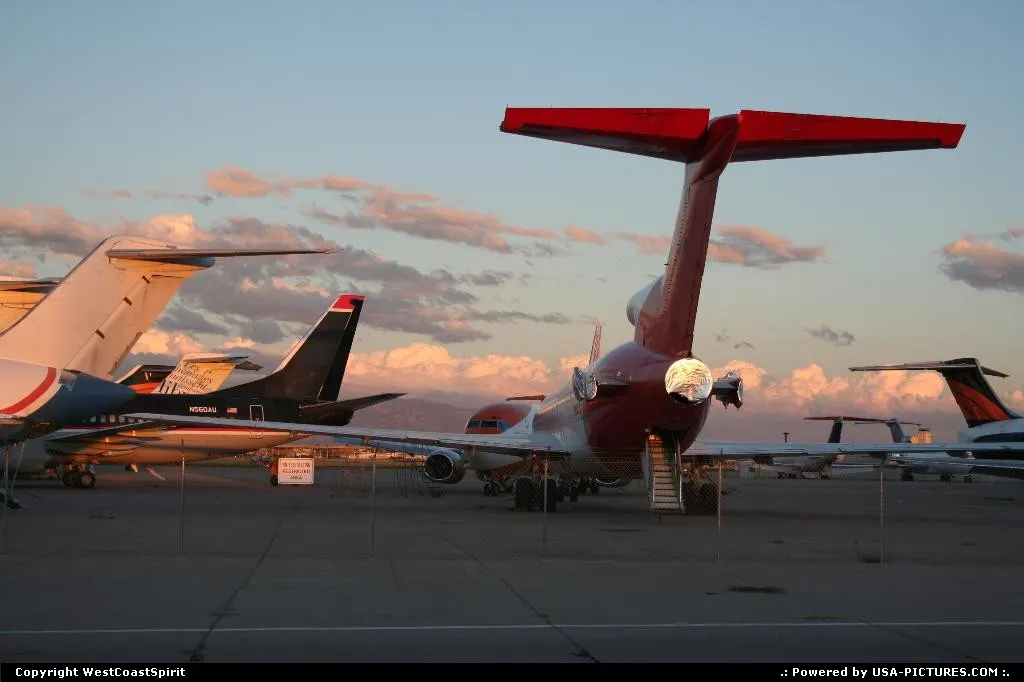 Preserved, engine-less Boeing 727 on a bright red and white livery resting on the appro...