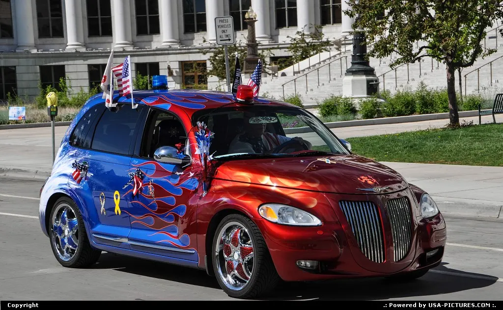 All American PT Cruiser parading in front of the City all in downtown Denver.