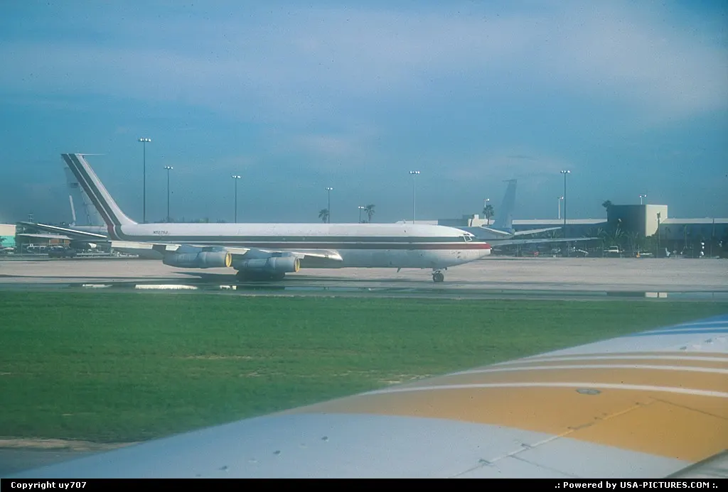 Passenger's view over one of Miami Intl's numerous cargo ramps hosted by a parked Boein...