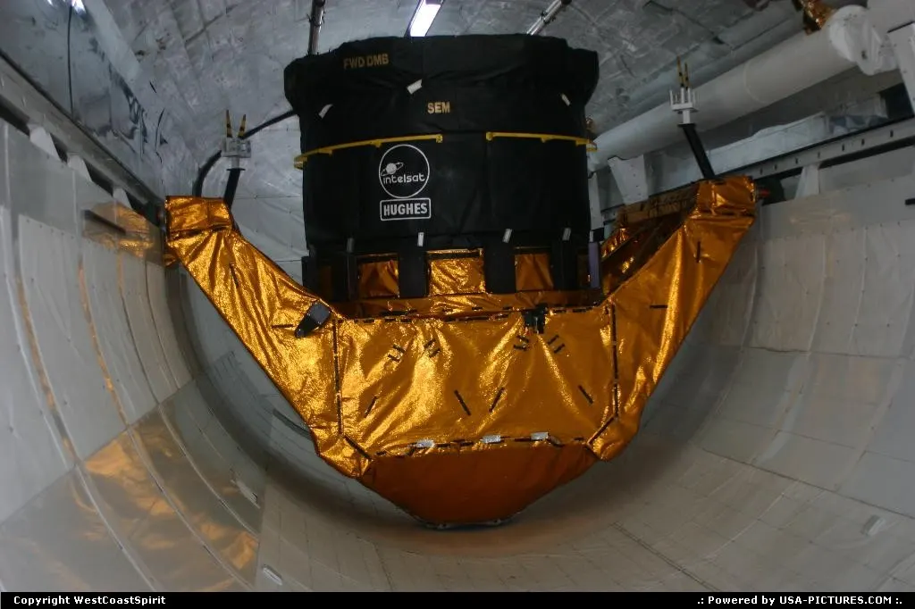 A satellite loaded into the cargo bay of the space shuttle. Kennedy Space Center.