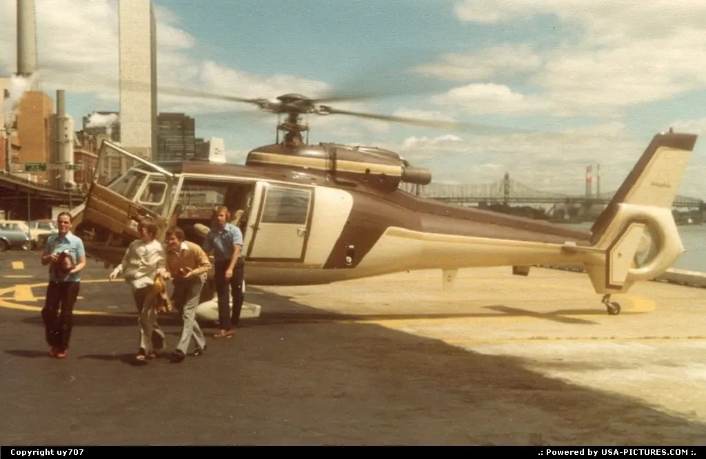 A party of happy visitors leaving an Island Helicopter SA365 Dauphin engine and rotors...