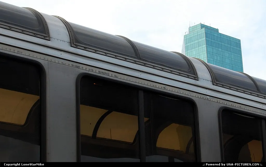 Fort Worth's Omni Convention Center Hotel rises above Amtrak's Texas Eagle as it sits i...