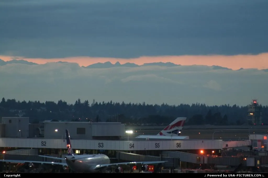 Airport overview, under an amazing sunset, with the mountains on the background.